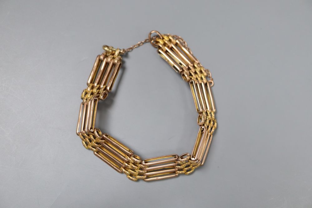 An early 20th century yellow metal (stamped 9c) gatelink bracelet, no clasp, overall 19cm,